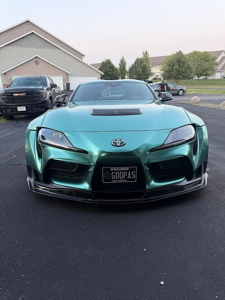 Front view of a green Toyota Supra after a hand wash