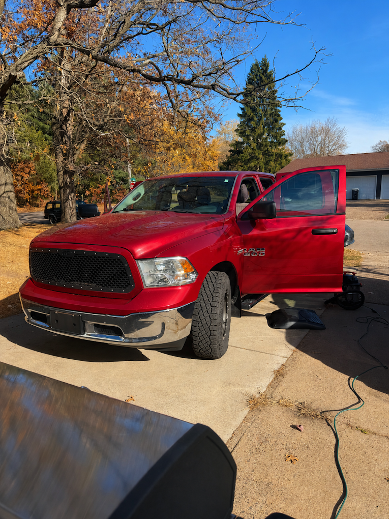 Red Ram pickup truck detailed in the driveway