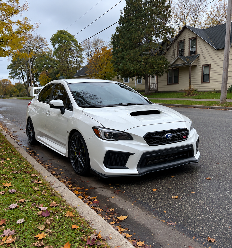 White Subaru WRX STI with clean glossy paint