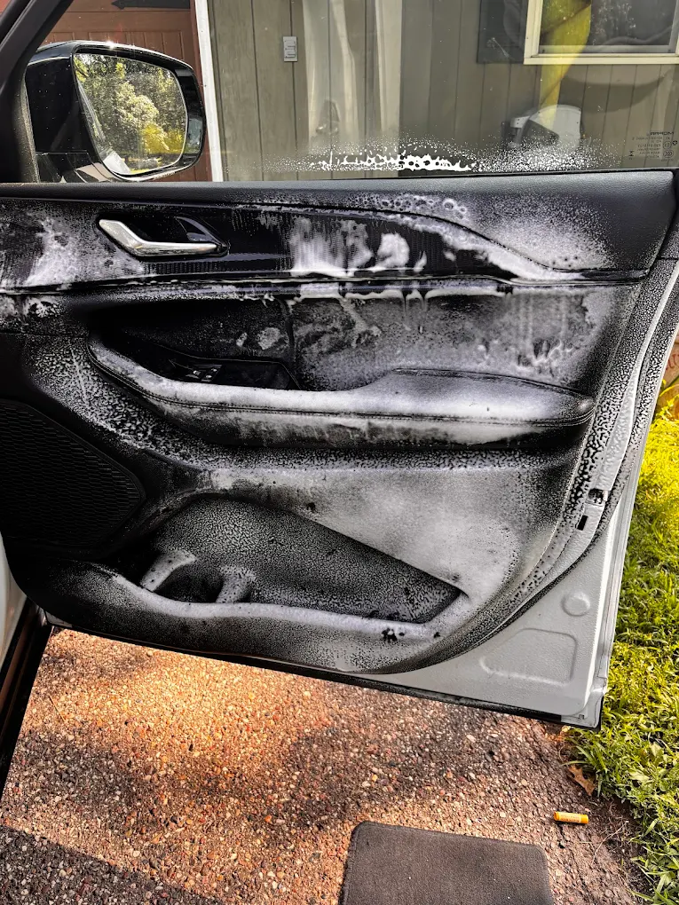 Door panel being deep cleaned with foam